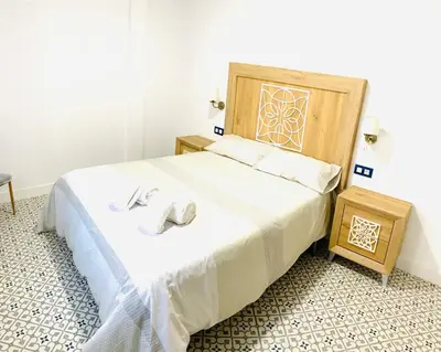 Cama o camas de una habitación en Al-Qazeres Suites