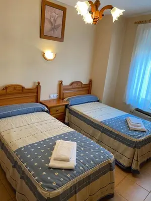 Cama o camas de una habitación en Hostal Jose Mari