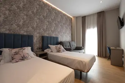 Cama o camas de una habitación en Hotel Aldama