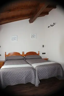 Cama o camas de una habitación en Hostal Extremeño