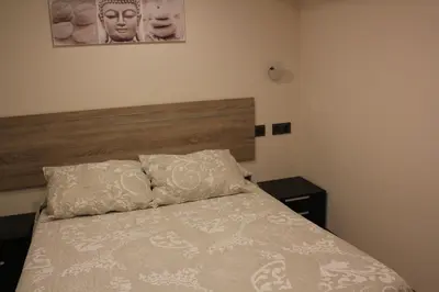Cama o camas de una habitación en Hostal Extremeño