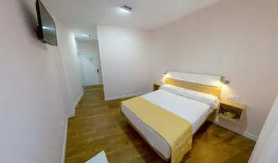Cama o camas de una habitación en ALOJAMIENTOS TAJO INTERNACIONAL