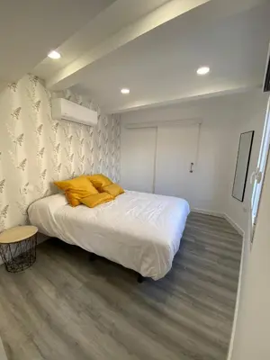 Cama o camas de una habitación en Apartamentos San Martín