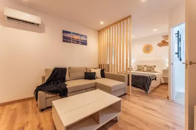 Cama o camas de una habitación en Apartamentos Turísticos Jardín del Albarregas