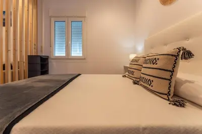 Cama o camas de una habitación en Apartamentos Turísticos Jardín del Albarregas