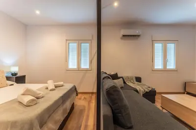 Cama o camas de una habitación en Apartamentos Turísticos Jardín del Albarregas