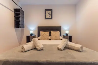 Cama o camas de una habitación en Apartamentos Turísticos Jardín del Albarregas