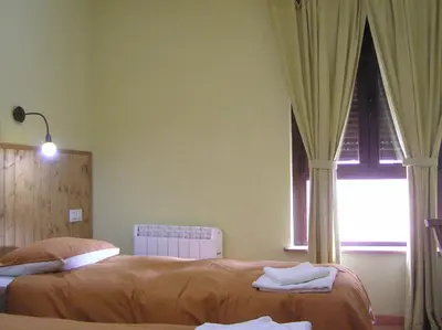 Cama o camas de una habitación en Hostal Rural Las Cuatro Calles
