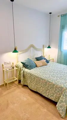 Cama o camas de una habitación en APARTAMENTO RURAL MIRADOR DE SIERRA BERMEJA