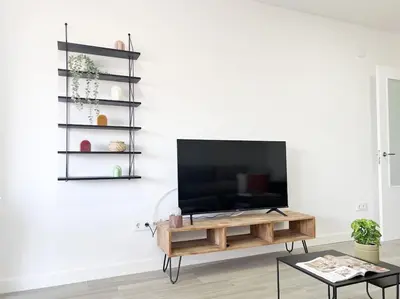 Una televisión o centro de entretenimiento en Apartamentos Gredos 103