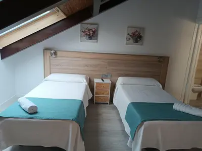 Cama o camas de una habitación en Apartamentos turisticos Ávila Puerta de Los Leales 1-2