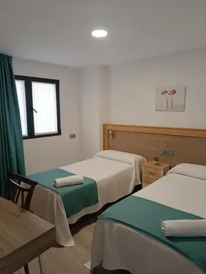 Cama o camas de una habitación en Apartamentos turisticos Ávila Puerta de San Isidro 1-4