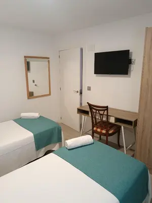Cama o camas de una habitación en Apartamentos turisticos Ávila Puerta de San Isidro 1-4