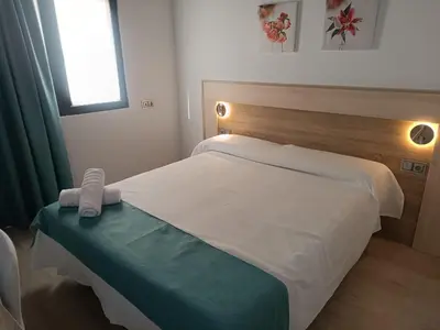 Cama o camas de una habitación en Apartamentos turisticos Ávila Puerta de la Santa 2-1