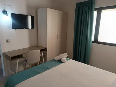 Cama o camas de una habitación en Apartamentos turisticos Ávila Puerta de la Santa 2-1