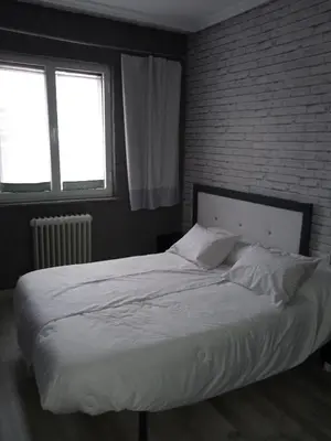 Cama o camas de una habitación en Alojamiento Roma