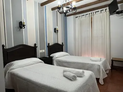 Cama o camas de una habitación en Hostal El Descanso Del Emperador