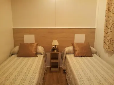 Cama o camas de una habitación en CAMPING-BUNGALOWS-CABAÑAS LA VERA