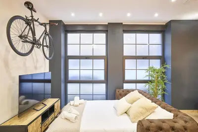Cama o camas de una habitación en Loft diseño el taller del abuelo con parking