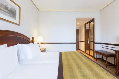 Cama o camas de una habitación en Dorma Reina Isabel