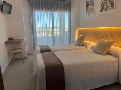 Cama o camas de una habitación en Hostal Parador de los Llanos