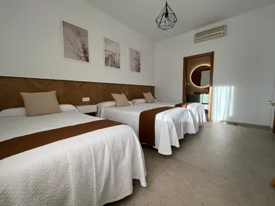 Cama o camas de una habitación en Hostal Parador de los Llanos