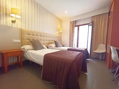 Cama o camas de una habitación en Hotel Rambla Emérita, centro ciudad