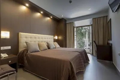 Cama o camas de una habitación en Hotel Rambla Emérita, centro ciudad