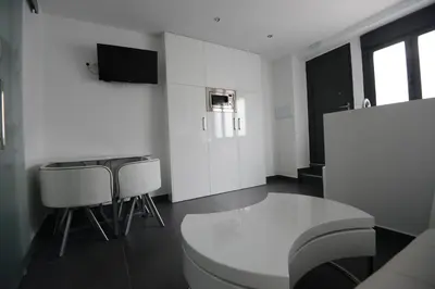 Una televisión o centro de entretenimiento en Apartamentos Torrecilla