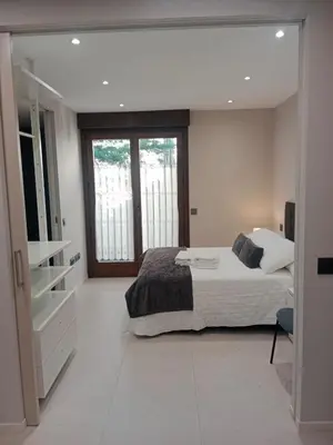 Cama o camas de una habitación en Apartamentos Living Libreros
