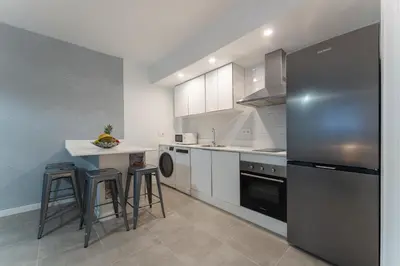 Una cocina o zona de cocina en Apartamentos Turísticos Lulú