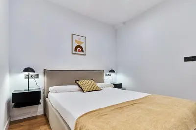 Cama o camas de una habitación en Apartamentos Beatriz by gaiarooms