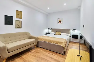 Cama o camas de una habitación en Apartamentos Beatriz by gaiarooms