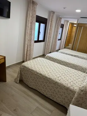 Cama o camas de una habitación en Hostal de Cazalegas