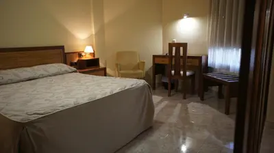 Cama o camas de una habitación en Hotel Puente Romano
