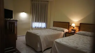 Cama o camas de una habitación en Hotel Puente Romano
