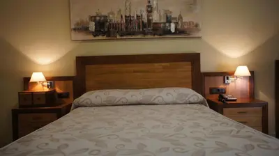 Cama o camas de una habitación en Hotel Puente Romano