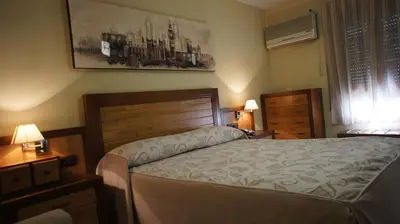 Cama o camas de una habitación en Hotel Puente Romano