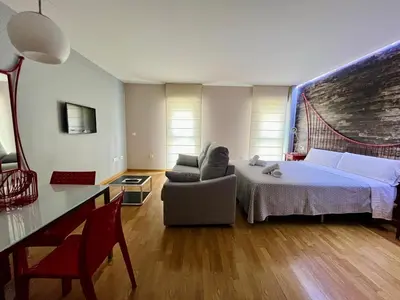 Cama o camas de una habitación en Apartamentos Suites Capitolio