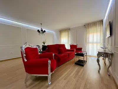 Una televisión o centro de entretenimiento en Apartamentos Suites Capitolio