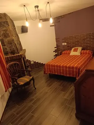 Cama o camas de una habitación en El Hogar del Castañar - Alojamiento en El Tiemblo