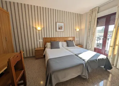 Cama o camas de una habitación en Hospedería Puerta de la Catedral