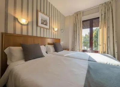 Cama o camas de una habitación en Hospedería Puerta de la Catedral