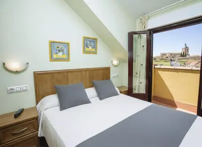 Cama o camas de una habitación en Hospedería Puerta de la Catedral