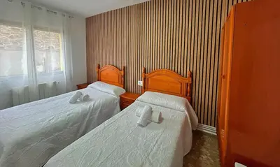 Cama o camas de una habitación en Apartamentos Turísticos Cardelemin