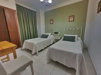 Cama o camas de una habitación en HOSTAl LUJUAN