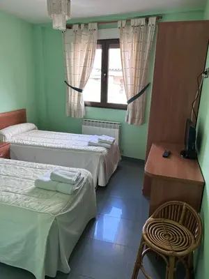 Cama o camas de una habitación en Hostal Rural Dos Hermanos