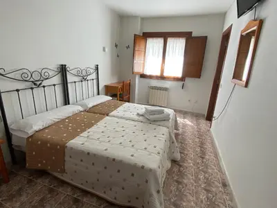 Cama o camas de una habitación en Hostal La Alberca