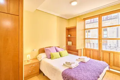 Cama o camas de una habitación en San Justo Suites
