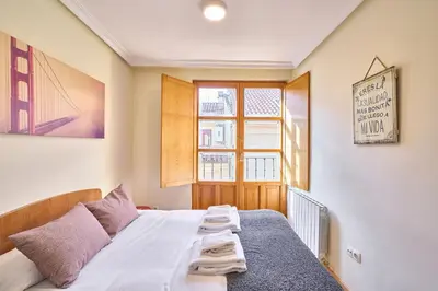 Cama o camas de una habitación en San Justo Suites